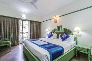 a bedroom with a large bed and a window at Fort Gate Hotels & Resorts in Trichūr