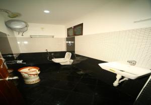 a bathroom with a toilet and a sink at Arudhra Residency in Chidambaram +57 photos