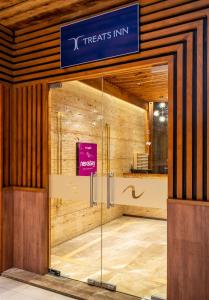 an entrance to a treats inn in a building at Nexstay Treats Inn in Kozhikode