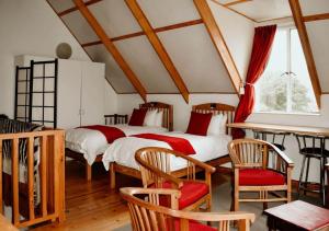two beds in a room with a table and chairs at Knock Out View Clarens in Clarens