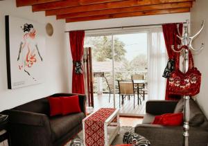 a living room with two couches and a table at Knock Out View Clarens in Clarens