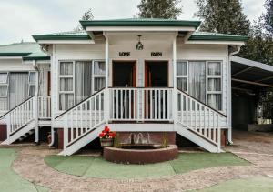 a house with a front porch with a fountain at Knock Out View Clarens in Clarens