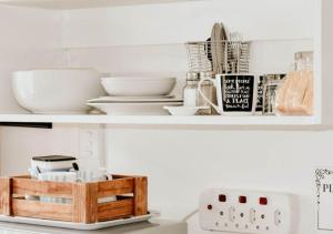 a shelf with bowls and other kitchen items on it at Knock Out View Clarens in Clarens