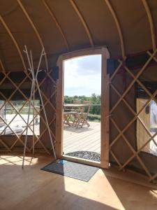 an open door in a yurt with a patio at Looe Yurts in Looe