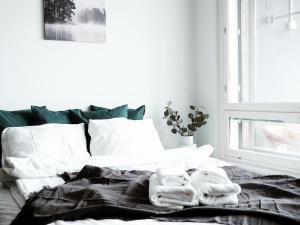 a bedroom with a bed with towels on it at "ESPA" - Modern 1BR Apartment with Sauna, Balcony & Free Parking, Hosted by 2ndhomes in Tampere