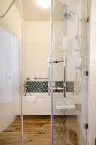 a bathroom with a shower with a glass door at Hotel Villa Baltica in Sopot
