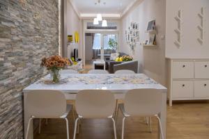 a kitchen and dining room with a table and chairs at The North Tower Apartment in Sofia