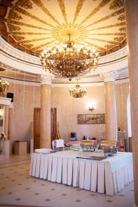 a large room with a table and a chandelier at INTOURIST Hotel in Volgograd