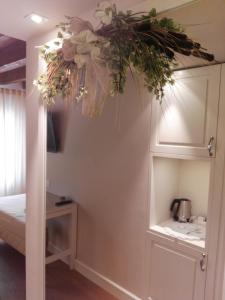 a room with a bed and a vase of flowers at Agriturismo Villa Trovatore in Cervignano del Friuli