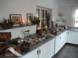 a kitchen with a buffet of food and candles at Landgasthof Weisses Lamm in Engelthal