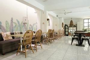 a dining room with a long table and chairs at Airlangga Hotel in Yogyakarta