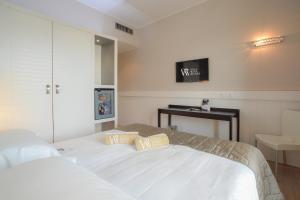 Cama ou camas em um quarto em Hotel Villa Rosa Riviera