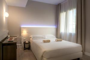 Cama ou camas em um quarto em Hotel Villa Rosa Riviera