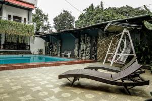 a house with a swing and a swimming pool at Airlangga Hotel in Yogyakarta