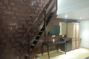 a staircase in a room with a desk and a wall at The Byke Brightland Adventure Park & Resort in Mumbai