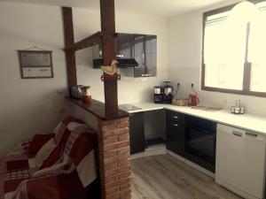 a kitchen with a brick fireplace in a kitchen at Marmottes in Font-Romeu-Odeillo-Via