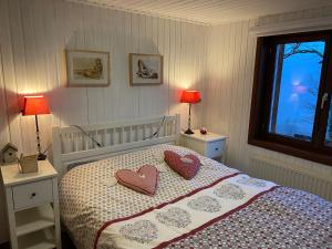 a bedroom with a bed with two hearts on it at Le Cap Vert in Rochehaut