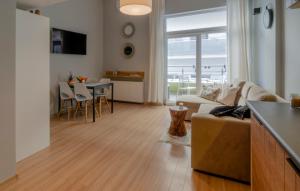 a living room with a couch and a table at Holiday Home LOFT in Międzyzdroje