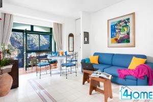 a living room with a blue couch and a table at Estate4home - RELAXING POSITANO in Positano