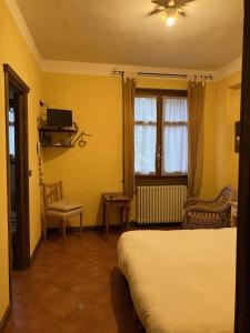 a bedroom with a bed and a window at Cascina La Maddalena Bed & Wine in Rocca Grimalda