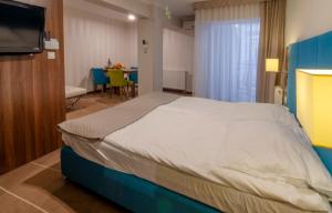 een slaapkamer met een groot bed en een tafel bij Holiday Home Aparthotel in Międzyzdroje