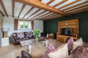 a living room with a couch and a table at Orchard House in Rosedale Abbey