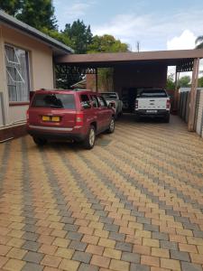 a parking lot with cars parked in a garage at AGT Guesthouse in Vryheid