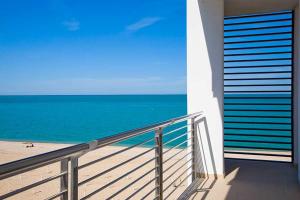 a balcony with a view of the beach and the ocean at Il Conero Mare in Numana