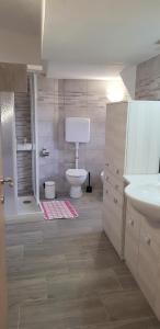 a bathroom with a toilet and a sink at Casa La Pief 2 Rosso by Gardadomusmea in Tremosine Sul Garda