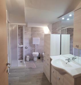 a bathroom with a sink and a toilet and a shower at Casa La Pief 2 Rosso by Gardadomusmea in Tremosine Sul Garda