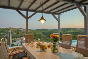 a table with flowers on top of a balcony at Villa San Mauro in Momjan