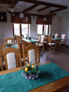 une salle à manger avec des tables et des chaises et une table au centre de Noël dans l'établissement Sadyba Cherry, à Pilipets