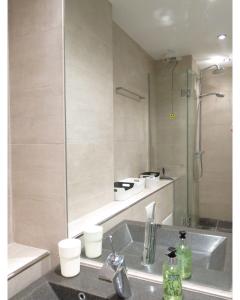 a bathroom with a sink and a shower at ApartmentInCopenhagen Apartment 936 in Copenhagen +12 photos