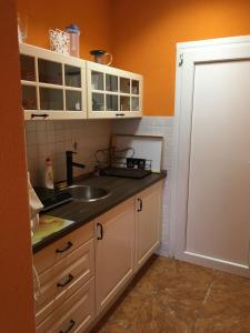 a kitchen with a sink and a counter top at Andrea Vendégház Székesfehérvár in Székesfehérvár