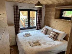a bedroom with a bed with towels on it at Just Morzine - Apartment Luna in Morzine +12 photos