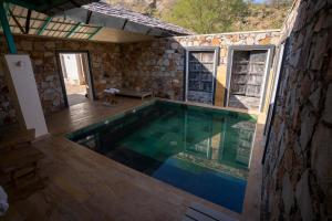 a swimming pool in the middle of a house at Trees N Tigers Luxury Wildlife Lodge in Akbarpur