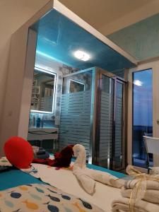 a child laying on a bed in a room with a mirror at Casa privata vacanze Relax piazza Maria Anania vico n4 in Crotone