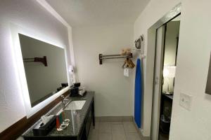 a bathroom with a sink and a mirror at Lx Hotel, Manchester, Tennessee in Manchester