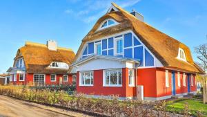 una casa roja y azul con techo marrón en Jade 2, en Born