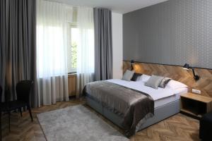 a hotel room with a bed and a window at Urban Boutique Hotel Center in Ljubljana