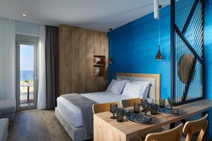 a hotel room with a bed and a table with plates on it at Theasea Stylish Residences in Panormos Rethymno