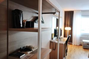 a room with a desk and a computer in a room at Hotell Roslagen by Atomis Hotels in Norrtälje