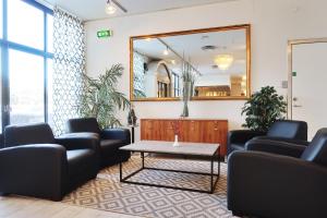 a waiting room with couches and a mirror at Optima Hotel Roslagen by Reikartz in Norrtälje +32 photos
