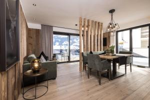 a dining room and living room with a table and chairs at Seven Reasons / Panorama View in Hart im Zillertal