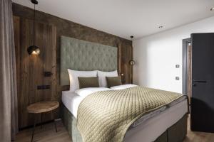a bedroom with a large bed with a large headboard at Seven Reasons / Panorama View in Hart im Zillertal