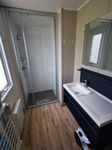 a bathroom with a large sink and a shower at Camping des Bondons in La Ferté-sous-Jouarre