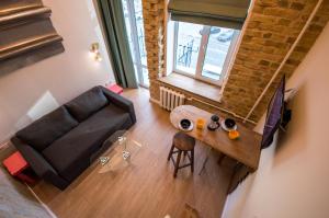 an overhead view of a living room with a couch and a table at Kyiv Whisky Box Apart-Hotel in Kyiv