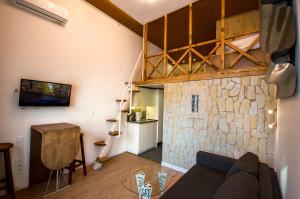 a living room with a couch and a stone wall at Kyiv Whisky Box Apartments in Kyiv