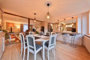a kitchen and dining room with a table and chairs at Au nid douillet in Metzeral
