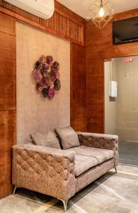 a living room with a couch and a flower wreath at Nexstay Treats Inn in Kozhikode